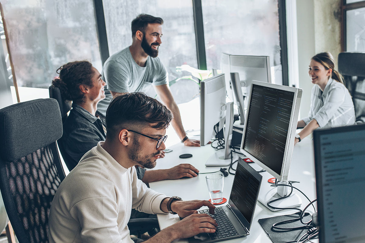 People working on computers in a modern office setting